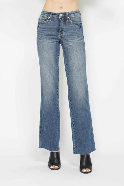 A woman posing in medium-wash tummy control straight jeans.
