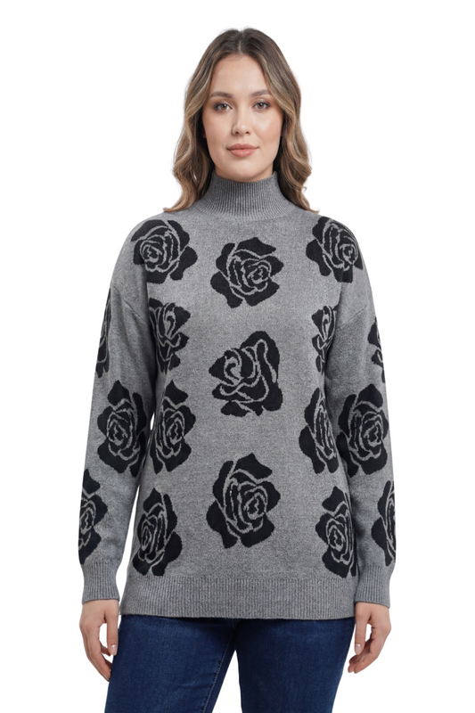 A woman posing in a gray sweater with black floral print.
