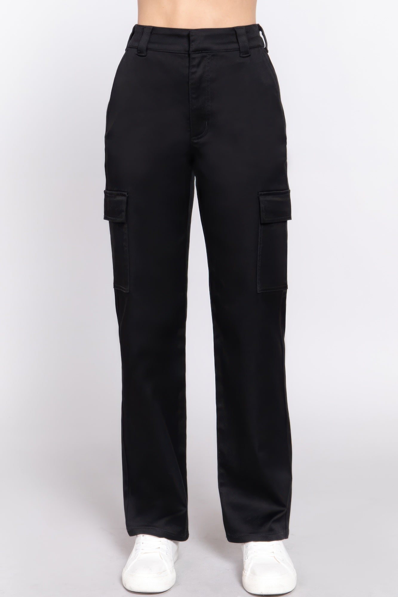 A woman posing in black straight fit long pants.