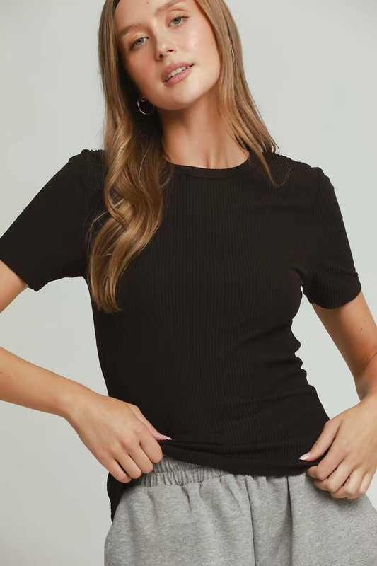 A woman posing in a black brushed rib short sleeve top.