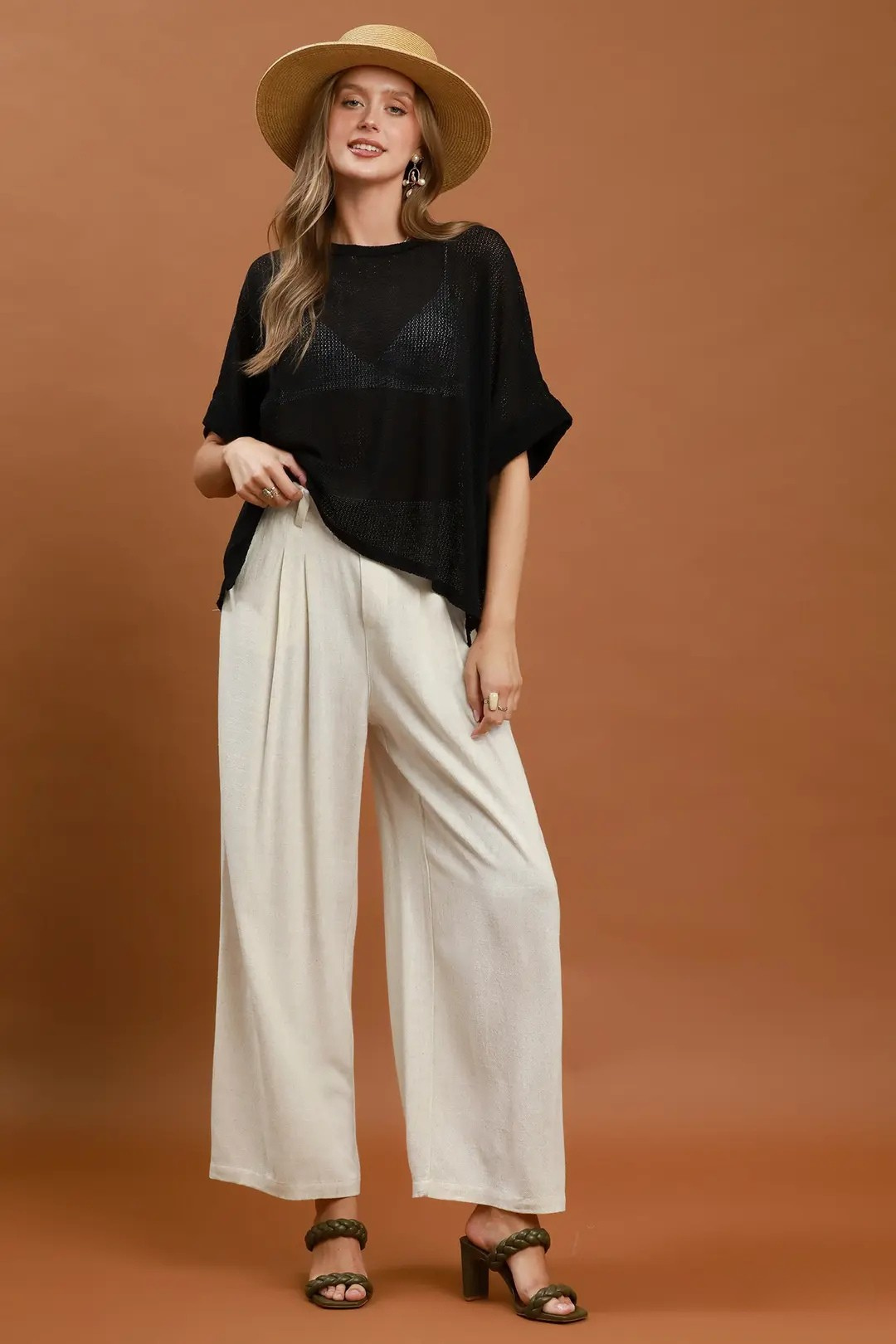 A woman posing in almond-colored high-waisted linen blend wide-leg trousers.