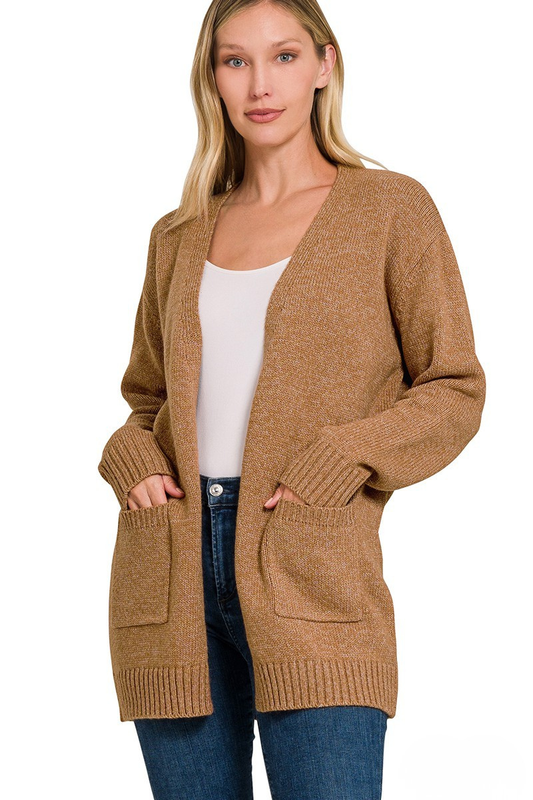 A woman posing in a deep camel brown open cardigan.