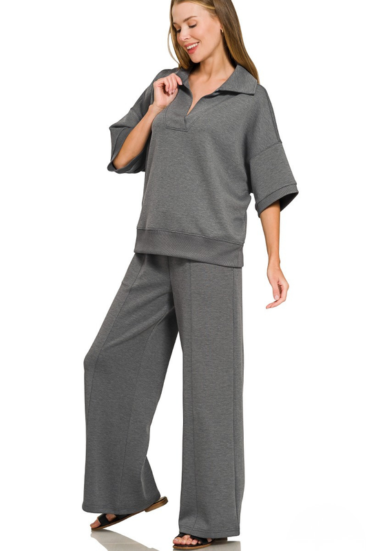 A woman posing in a gray scuba fabric collar pullover and center seam pants set.