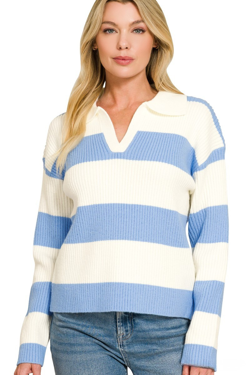A woman posing in a cornflower blue and white striped collar sweater.